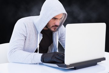 Cyber criminal is hacking from a laptop 