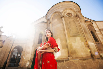 Sun shines over stunning woman dressed like an Indian bride