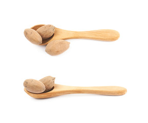 Wooden spoon and pecan nut composition