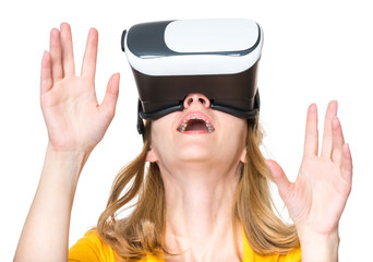 Amazed woman wearing virtual reality goggles watching movies or playing video games, isolated on white. Surprised girl looking in VR glasses. People experiencing 3D gadget technology.