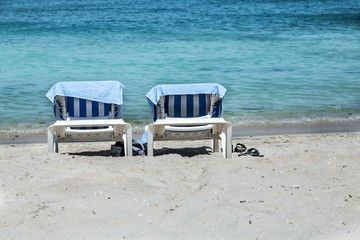 Two Chaise Lounges on Beach