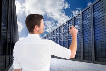 Businessman is drawing against database background 