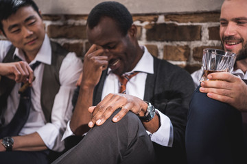 Portrait of three smiling businessmen resting together after work