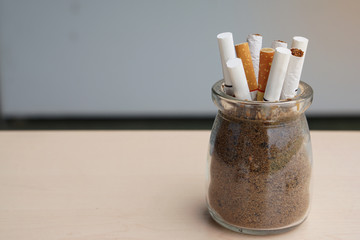  Cigarette butts in ashtray with copy space - May 31st, World No Tobacco Day, No Smoking Day, Stop Smoking Concept and Between tobacco and the health, choose health.