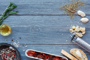 Italian cuisine ingredients background on blue rustic wood, copy space