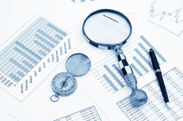Compass and magnifying glass on the market reports
