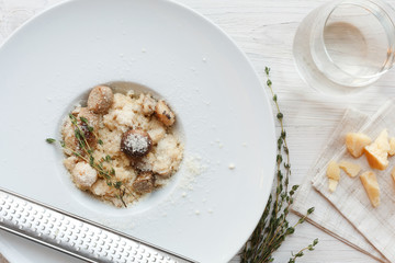 Wild mushrooms risotto with rosemary and parmesan, italian cuisine closeup