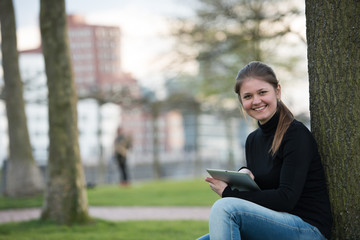 woman with tablet pc in park