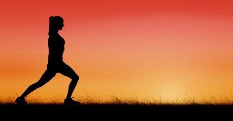 Silhouette woman exercising against sky during sunset