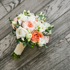 Bridal bouquet on the wooden floor