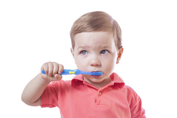 Cute baby boy brushing teeth