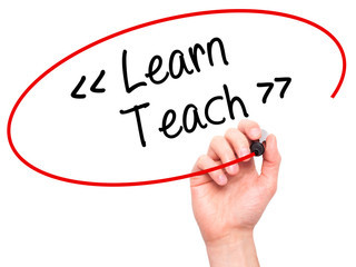 Man Hand writing Learn - Teach with black marker on visual screen.