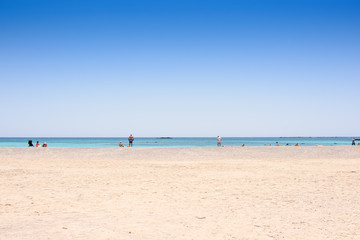 Fototapeta na wymiar Sandy beach on an island with blue sea and blue sky