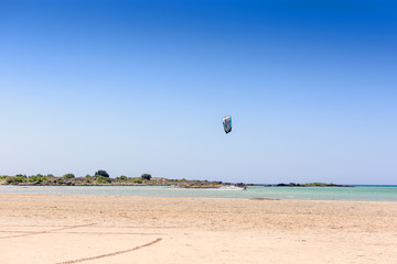 Sandy beach on an island with blue sea and blue sky