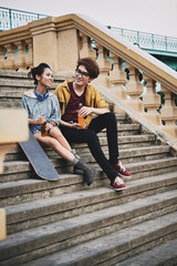 Joyful Skateboarders Relaxing Outdoors