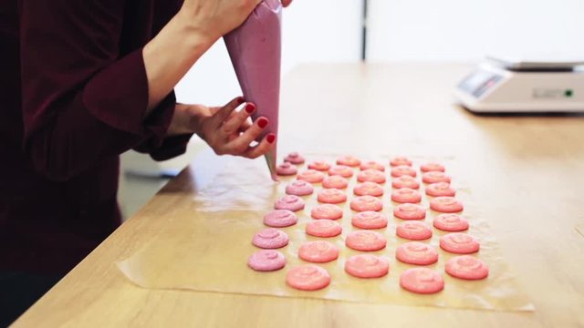 chef with injector squeezing macaron batter