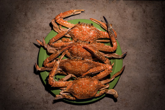 Grilled flower crabs at campfire.