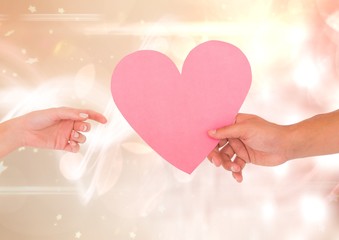 Hands with heart and sparkling light bokeh background