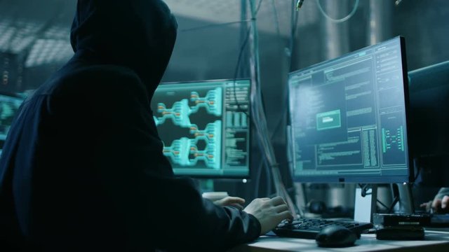 Young Hacktivist Organizes Malware Attack on Global Scale. They're in Underground Secret Location Surrounded by Displays and Cables. Shot on RED EPIC-W 8K Helium Cinema Camera.