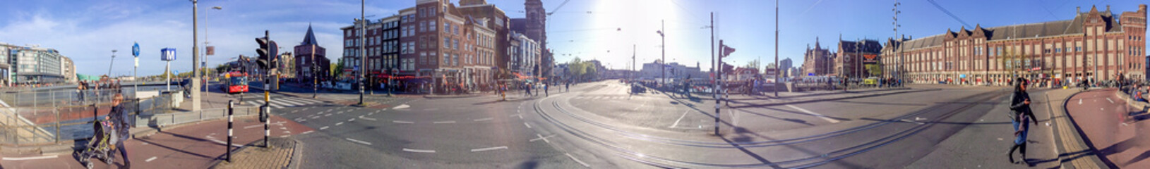 AMSTERDAM - APRIL 2015: Tourists walk along city streets. The city attracts 15 million people annually