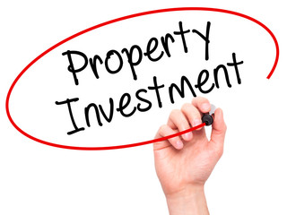 Man Hand writing Property Investment with black marker on visual screen