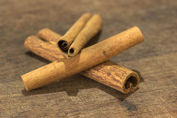 closeup detail of cinnamon sticks on wooden board