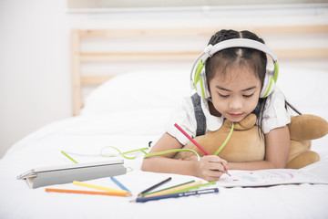 Asia girl drawing on a large sheet of white paper