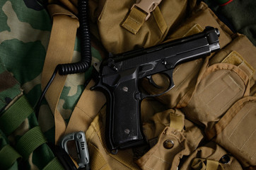 Pistol gun with military equipment.