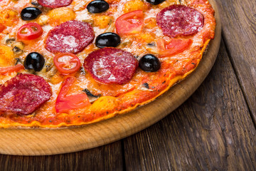 Delicious pizza with salami, mushrooms and olives