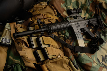 Assault rifle carbine with tactical chest rigs. Military Equipment.