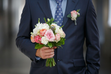 Wedding bouquet in Groom's hands