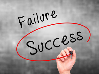 Man Hand writing and choosing, Success instead of Failure, with black marker on visual screen