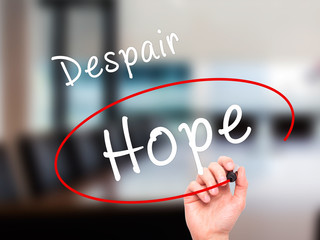 Man Hand writing and choosing Hope instead of Despair with black marker on visual screen
