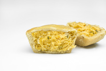 One cut traditional Brazilian mini chicken pie called empada in white background