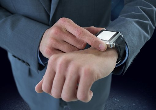 Businessman holding watch with dark ground background