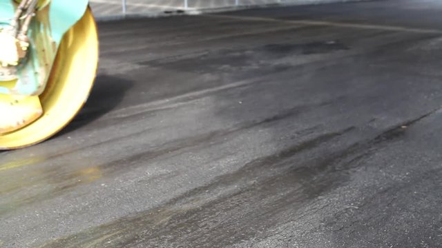 Pavers and rollers repair asphalt road in a city