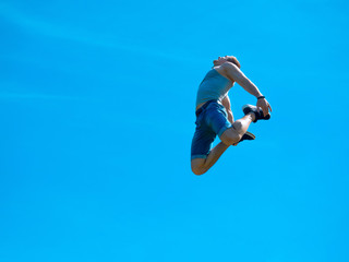 Jumping up guy. Background blue sky.