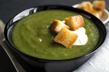 vegetarian cream soup of green vegetables. on a black background