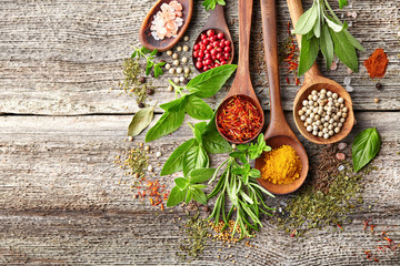 Herbs and spices on a wooden board - obrazy, fototapety, plakaty