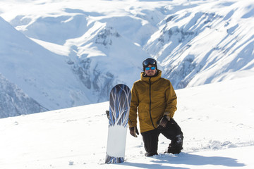 Fototapeta na wymiar snowboarder snowboarding on fresh white snow with ski slope on Sunny winter day
