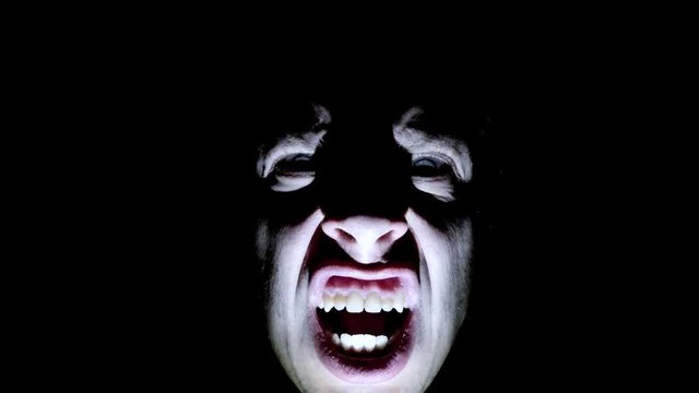 Horror scene screaming man face. Scary evil many faces. Devil spiritual exorcism. close up top view.