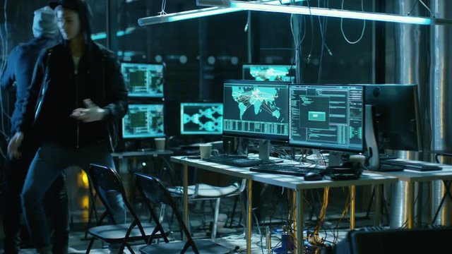 Group Of Internationally Wanted Hackers Run From from They're Busted Hideout. Place Has Many Displays and Cables, Dark Neon.