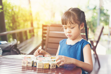 Little girl  palying with wooden cubes ,Educational Learning Conceptsa