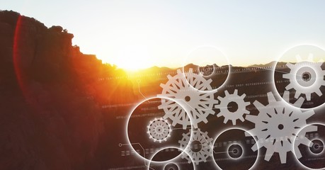 White gear graphics against mountain and sunset