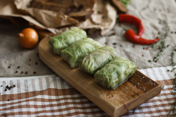 Composition with different spices and mortar on dark wooden background.