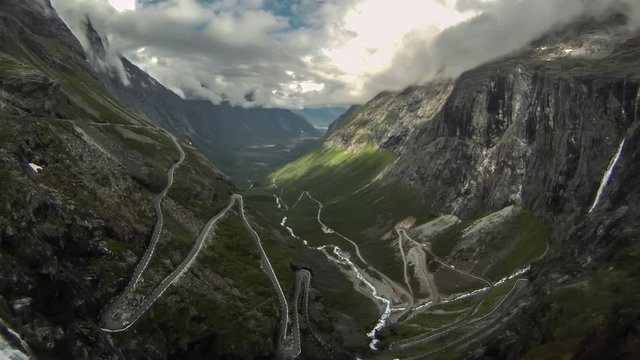 Trollstigen. Is a serpentine mountain road in Rauma Municipality. It is a popular tourist attraction due to its steep incline of 10% and eleven hairpin bends up a steep mountainside
