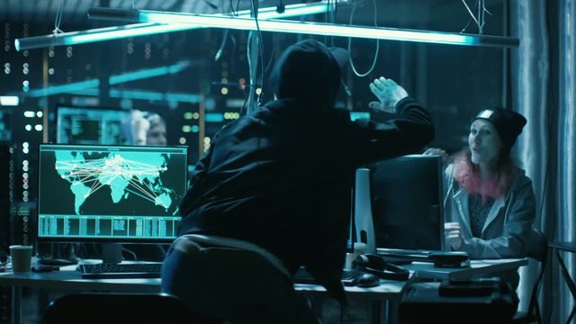 Team of Teenage Hackers Successfully Attack Global Infrastructure Servers, They High-Five. Display Showing Stages of Hacking in Progress: Exploiting Vulnerability, Executing and Granted Access. 