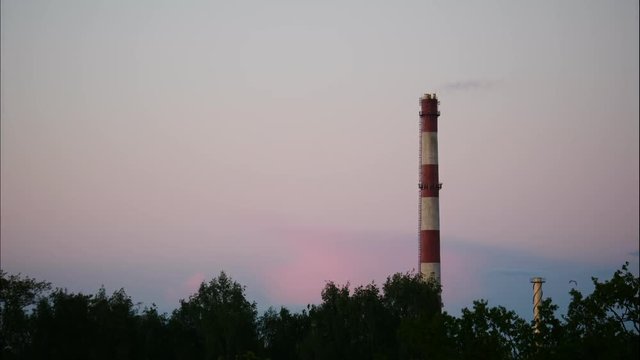 Sunset Time Lapse Sky and moving clouds Power Plant pipe with smoke Latvia 4K