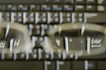 blurry computer notebook keyboard through far sight eyeglasses