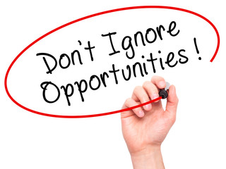 Man Hand writing Don't Ignore Opportunities black marker on visual screen